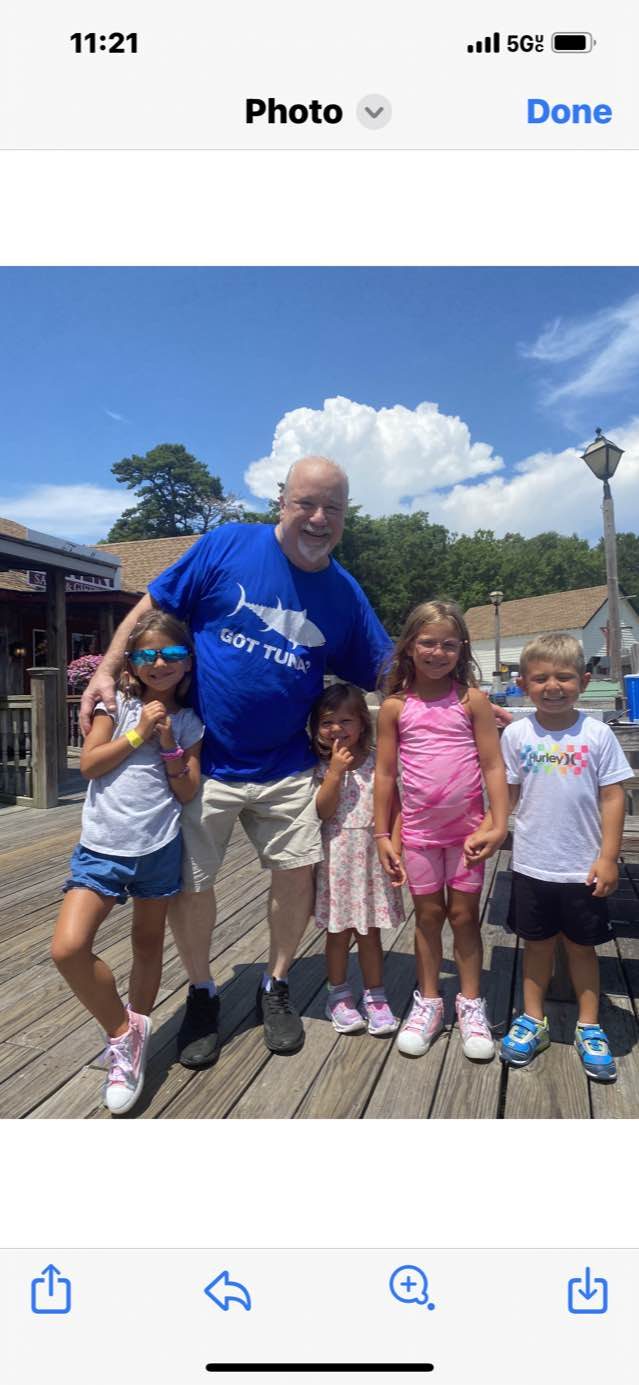 Don smiling with grandkids outside Oyster Creek