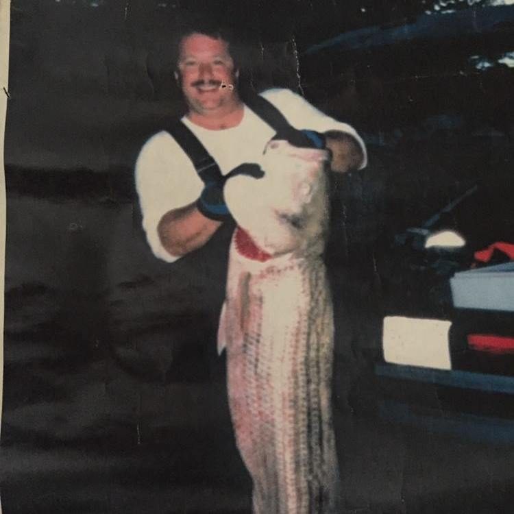 A younger Don holding a large striped bass